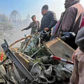 Rescuers gather at the site of a plane crash in Pokhara after an airplane crashed with 72 people on board in Nepal