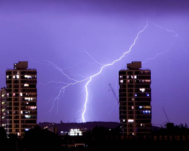 Lightning flashes in the night sky over south London. A weather warning is in place for thunderstorms today (Sunday, June 18) across England, Wales and Northern Ireland.