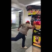 Man misses punch bag and hits boxing machine.