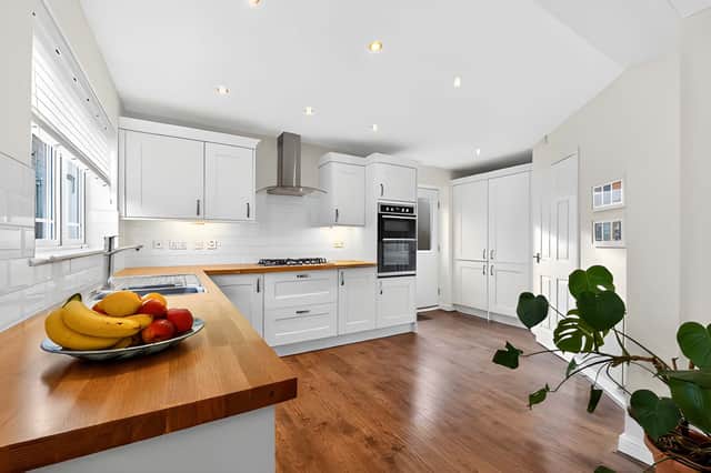 The modern kitchen and dining area provides a practical heart to the house