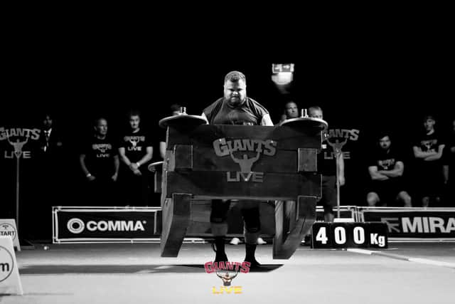 Tom Place powering through the brutal 400kg wooden oak frame carry over 20 metres at the York Barbican.