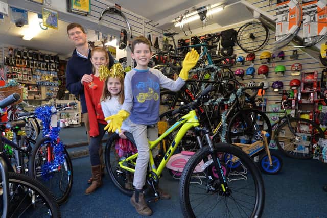 The winner James Thompson, 9, collects the bike from Meriel Buxton, chairman, and Neil Holman of George Halls Cycle Centre and also sponsored by King West.