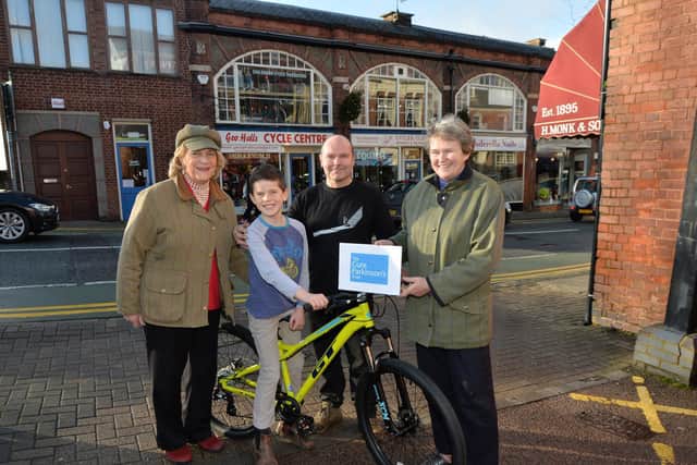 Pedal power...James Thompson, 9, winner of the Cure Parkinson Trust bike raffle with from left Carolynn Thompson (grandmother) Neil Holman of George Halls Cycle Centre and Meriel Buxton, chairrman of the Cure Parkinson Trust Local group.