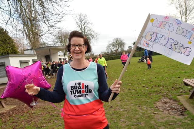 Catherine Searcy celebrates after finishing her last mile in aid of The Brain Tumour Charity.