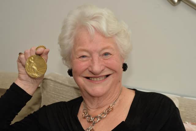 Mary Peters with her gold medal at Elizabeth Place.
PICTURE: ANDREW CARPENTER