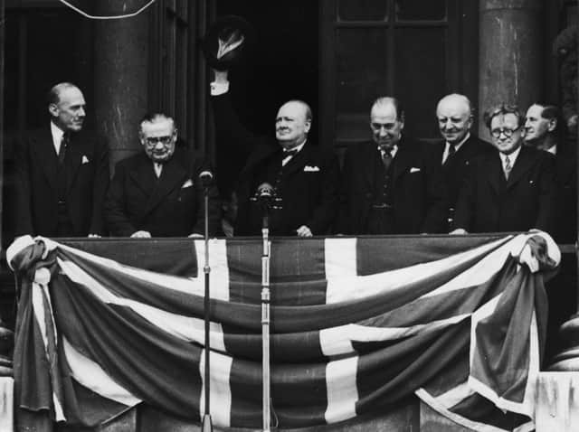 British Prime Minister Winston Churchill (1874 - 1965) addresses the crowds from the balcony of the Ministry of Health in Whitehall on VE Day, 8th May 1945. From left to right, Ernest Bevin (1881 - 1951), Churchill, Sir John Anderson (1882 - 1958), Lord Woolton and Herbert Morrison (1888 - 1965). (Photo by Central Press/Hulton Archive/Getty Images).