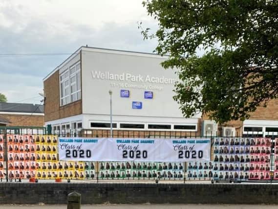 The proud 15 and 16-year-olds are loving having their pictures plastered all over the front of Welland Park Academy on busy Welland Park Road.