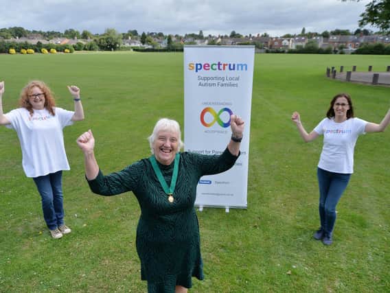 Boost...chairman Barbara Johnson hands over 4,000 to Emma Page and Joy Hanlon of Spectrum after her year in office.
PICTURE: ANDREW CARPENTER