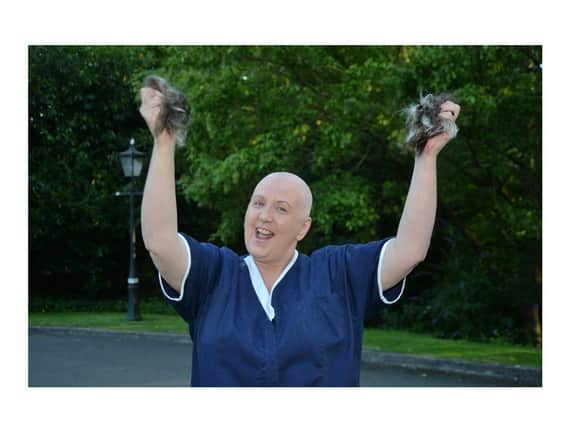 Michele Tate celebrates after her head shave for Macmillan Cancer at the Willows Nursing Home.
PICTURE: ANDREW CARPENTER