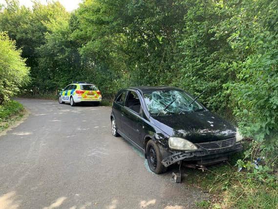 Officers found the battered black hatchback wedged into the verge on a narrow country lane near Saddington, north-west of Market Harborough.