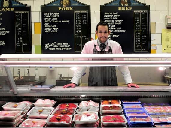 Kris Moore, who owns John Ross Butchers in the indoor markets Food Hall.