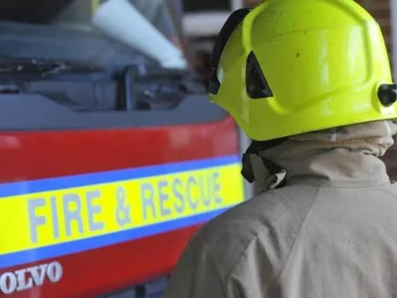 A man was rescued by firefighters in a Harborough village after ending up trapped under a car.