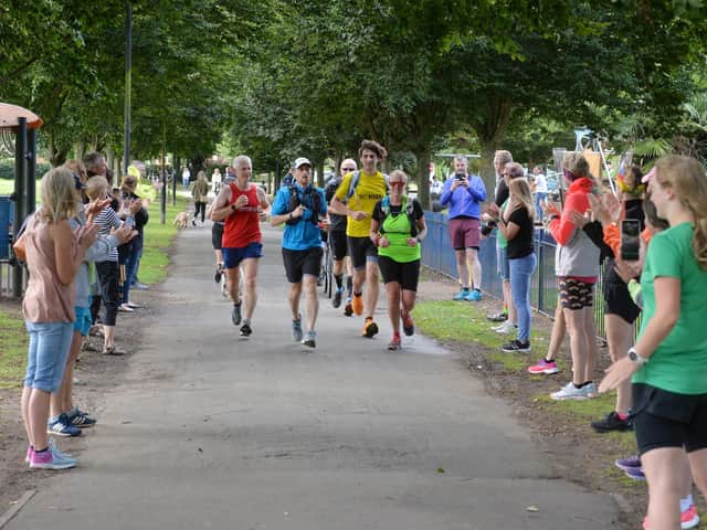 Market Harborough social runners cross the finish line in Welland Park during their marathon relay on Saturday.
PICTURE: ANDREW CARPENTER