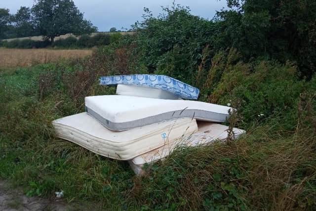 Fly-tippers have dumped five filthy mattresses on farmland on the edge of Market Harborough.