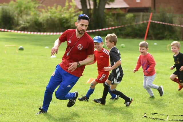 Coach John Mulholland with youngsters during the Kibworth get active day.
PICTURE: ANDREW CARPENTER