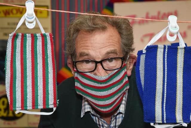 Paul Hall with his retro reflective face masks at Harborough indoor market.
PICTURE: ANDREW CARPENTER