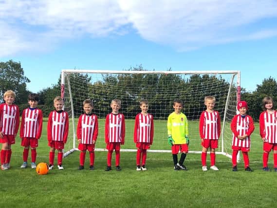 Thompsons United FC with their new strips and goalposts, thanks to housebuilder Mulberry Homes.