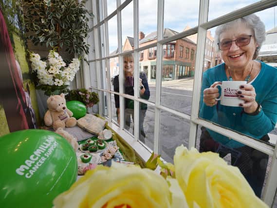 Raising a mug...Gail Devereux-Batchelor of Home Instead with Eunice Loney of Market Harborough Group of Macmillan Cancer Support outside the Macmillan dressed window at HomeInstead on St Mary's Road..
PICTURE: ANDREW CARPENTER
