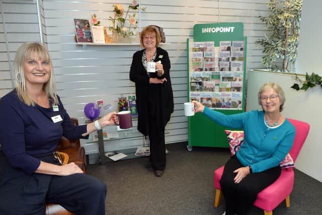 Raising a mug...Gail Devereux-Batchelor, Angela Farrow of Home Instead with Eunice Loney of Market Harborough Group of Macmillan Cancer Support.
PICTURE: ANDREW CARPENTER