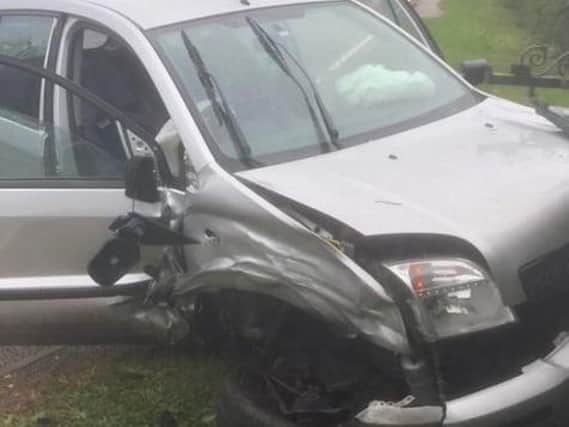 Two cars collided head-on in a crash in torrential rain in a Harborough village.