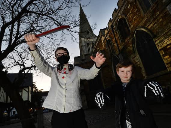 Hunter McCoy 13 and Jack McCoy 7 outside St Dionysius during the churches halloween superhero light trail.
PICTURE: ANDREW CARPENTER
