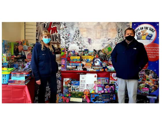 Cllr Phil King, the leader of Harborough council, with Pat Stones from Hfm as they admire just some of the toys brought in.