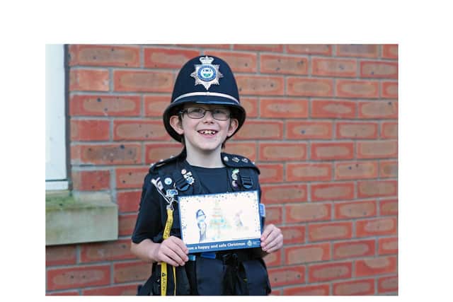Jay with his Christmas card design - and in his police uniform.