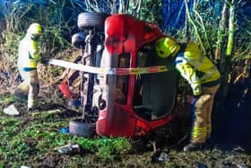 Two injured people were rushed to hospital after a car went off the road and flipped over on to its side on a country road near Lutterworth.