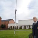 Rev John Morley with the flag at half mast in memory of Captain Sir Tom Moore in the memorial gardens.
PICTURE: ANDREW CARPENTER