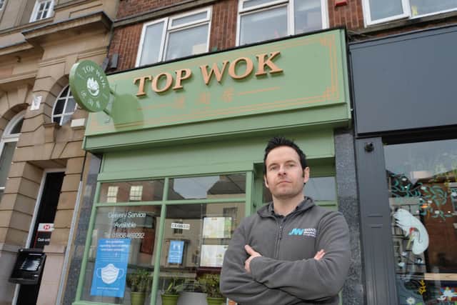 Shane Cross outside the new signage on Top Wok.
PICTURE: ANDREW CARPENTER