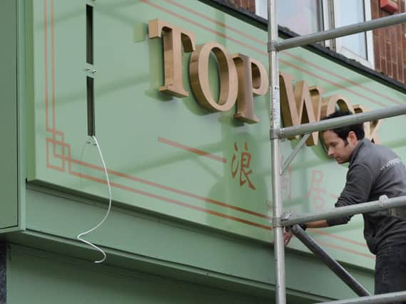 Shane Cross working on the new signage at Top Wok.
PICTURE: ANDREW CARPENTER