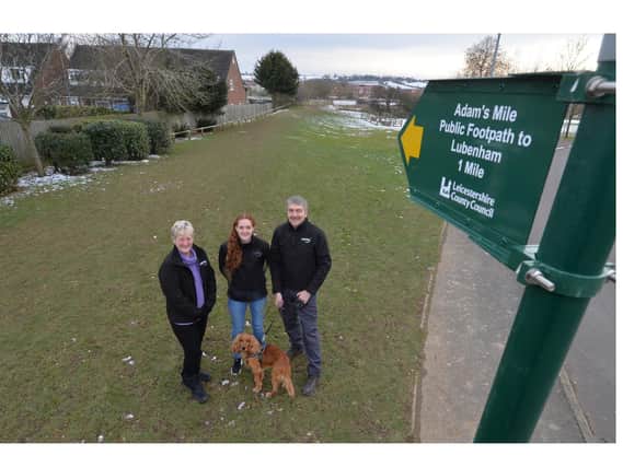 Kate, Lucie and David Mugridge with Simba with the AdamSmile sign on Farndale View in Market Harborough.
PICTURE: ANDREW CARPENTER