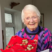 100-year-old Eileen Payne with her beautiful flowers and a card on her birthday.