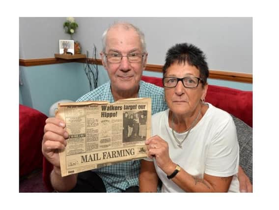 Carole Tilley with her husband Allan, holding an old story about the Hippo Appeal.