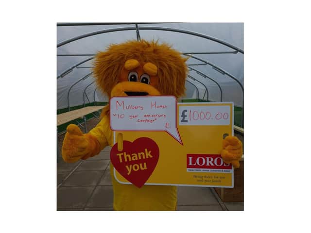 Lionel the Lion, LOROS' mascot, in front of the Poly Tunnel.