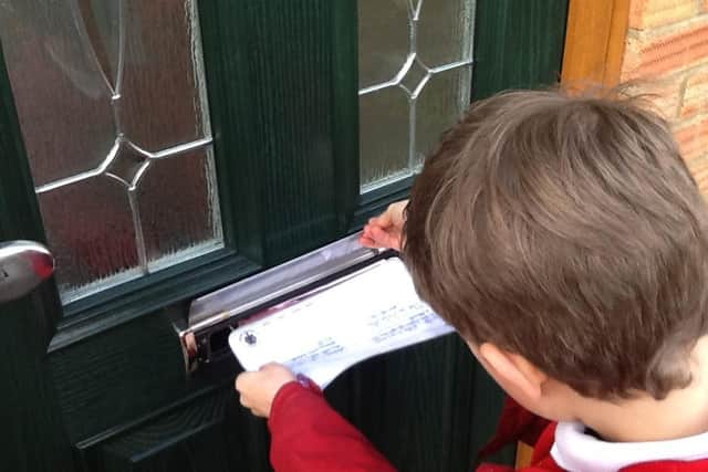 Cottingham schoolchildren delivering postcards to neighbours, as part of their recent Values Day.