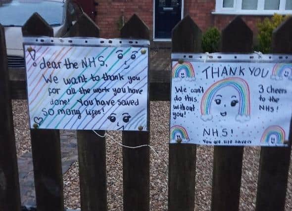 Two posters attached to the front fence of their home in Lubenham Hill, Harborough.