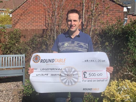 Market Harborough Round Table chairman David Moore with the cheque.