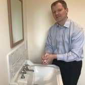 Neil O'Brien MP washing his hands.