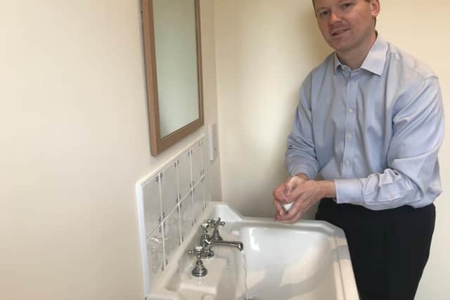 Neil O'Brien MP washing his hands.