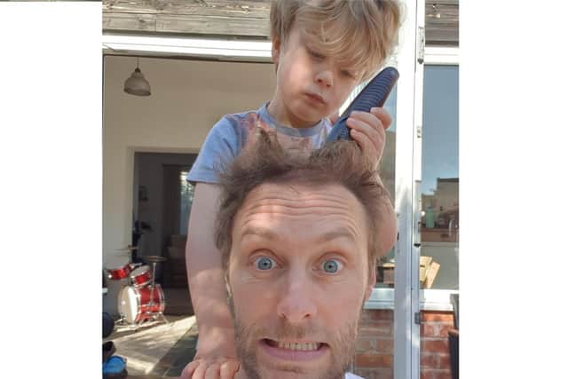 Nick Bradley gets his hair cut by his four-year-old son.