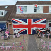 Michael Crook of Willow Crescent celebrates VE Day with his huge union jack flag and neighbours.
PICTURE: ANDREW CARPENTER
