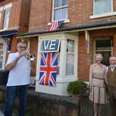 John Pacey plays the last post in Market Harborough with neighbours Helen and Dave Allen on Nelson Street.