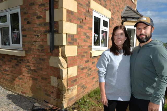 Katie and Jack Walther survey the damage to their house after a car ploughed into it on Dunkirk Avenue, Desborough. PICTURE: ANDREW CARPENTER