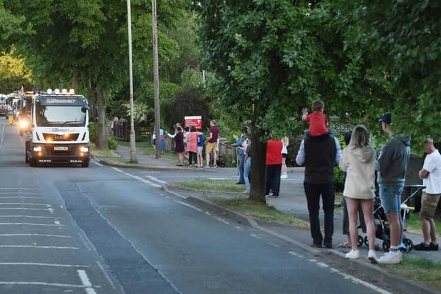 Scores of residents on Lubenham Hill clap and cheer the final convoy in Market Harborough for NHS and key workers. PICTURE: ANDREW CARPENTER