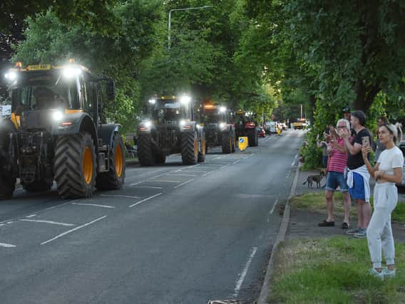 Residents on Lubenham Hill clap and cheer the final convoy in Market Harborough for NHS and key workers. PICTURE: ANDREW CARPENTER