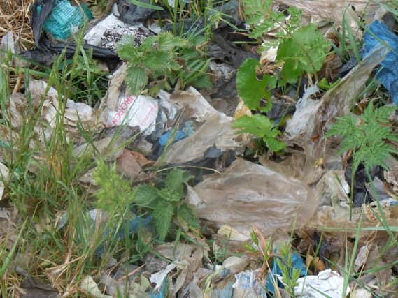 Work is starting on clearing up a massive sea of plastic waste scattered across a farm field and countryside trail on the outskirts of Market Harborough.