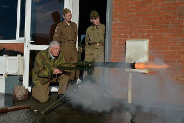 Neil Hunt demonstrates one of his weapons during the open day.
PICTURE: ANDREW CARPENTER