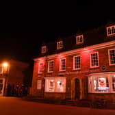 Market Harborough Building Society was lit up in strikingly symbolic red as townspeople paid tribute to servicemen and women killed in the two world wars as well as in all other conflicts over the years.