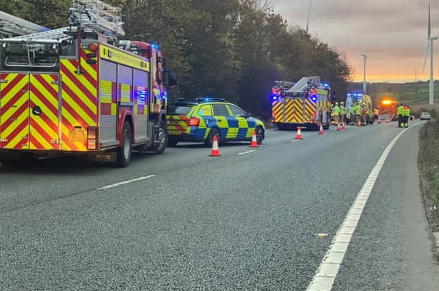 Firefighters raced to free an injured woman from her wrecked car after a three-vehicle crash on the A14.